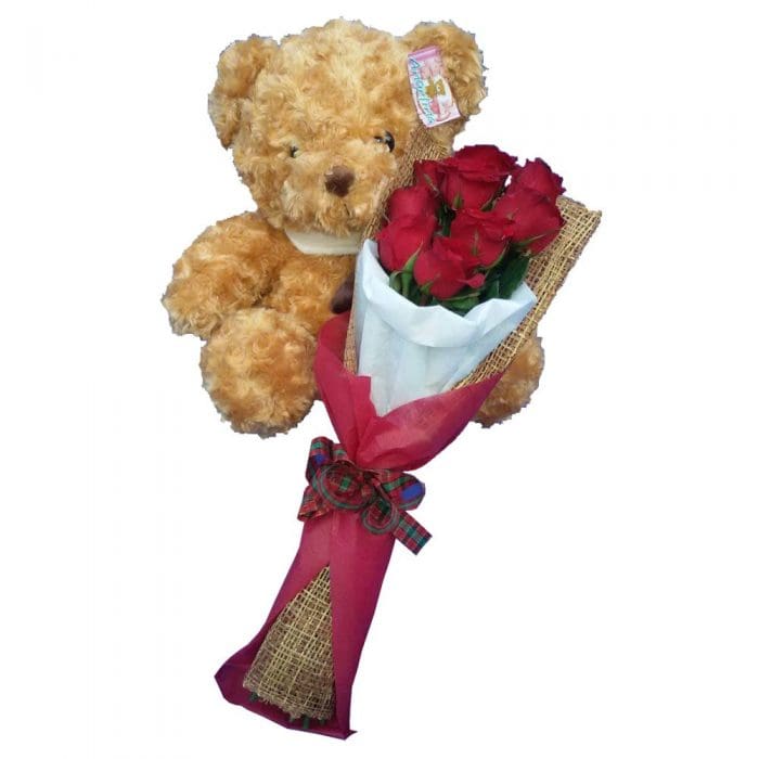 Traditional brown Teddy Bear together with a bunch of Red Rose